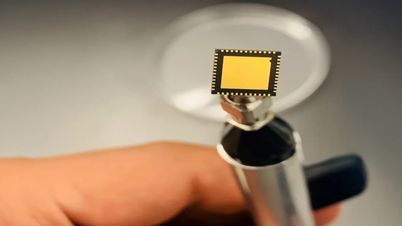 Close-up view of a microfabricated sensor chip used in advanced biomedical and communication systems.